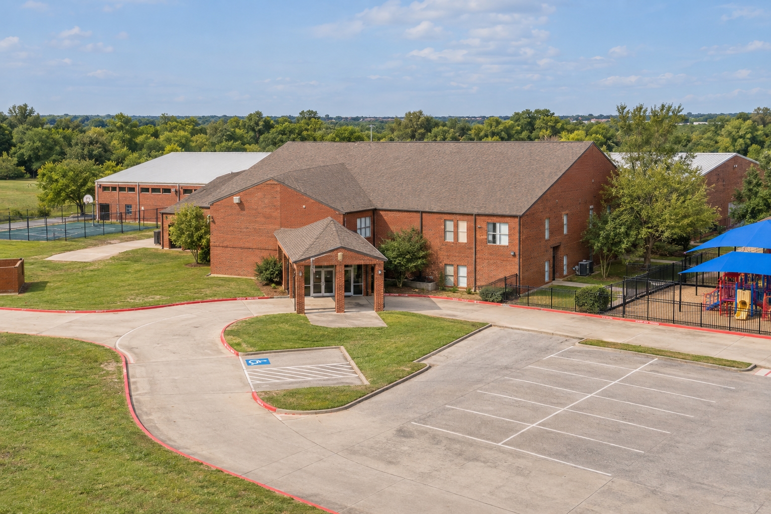 Campus illustration of Ovilla Christian School’s red-brick building, covered entrance and campus grounds